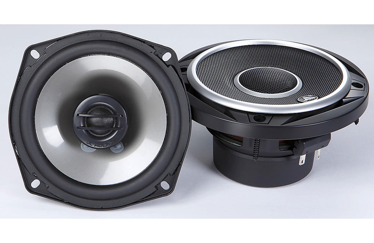 Pair of car speakers on a white 