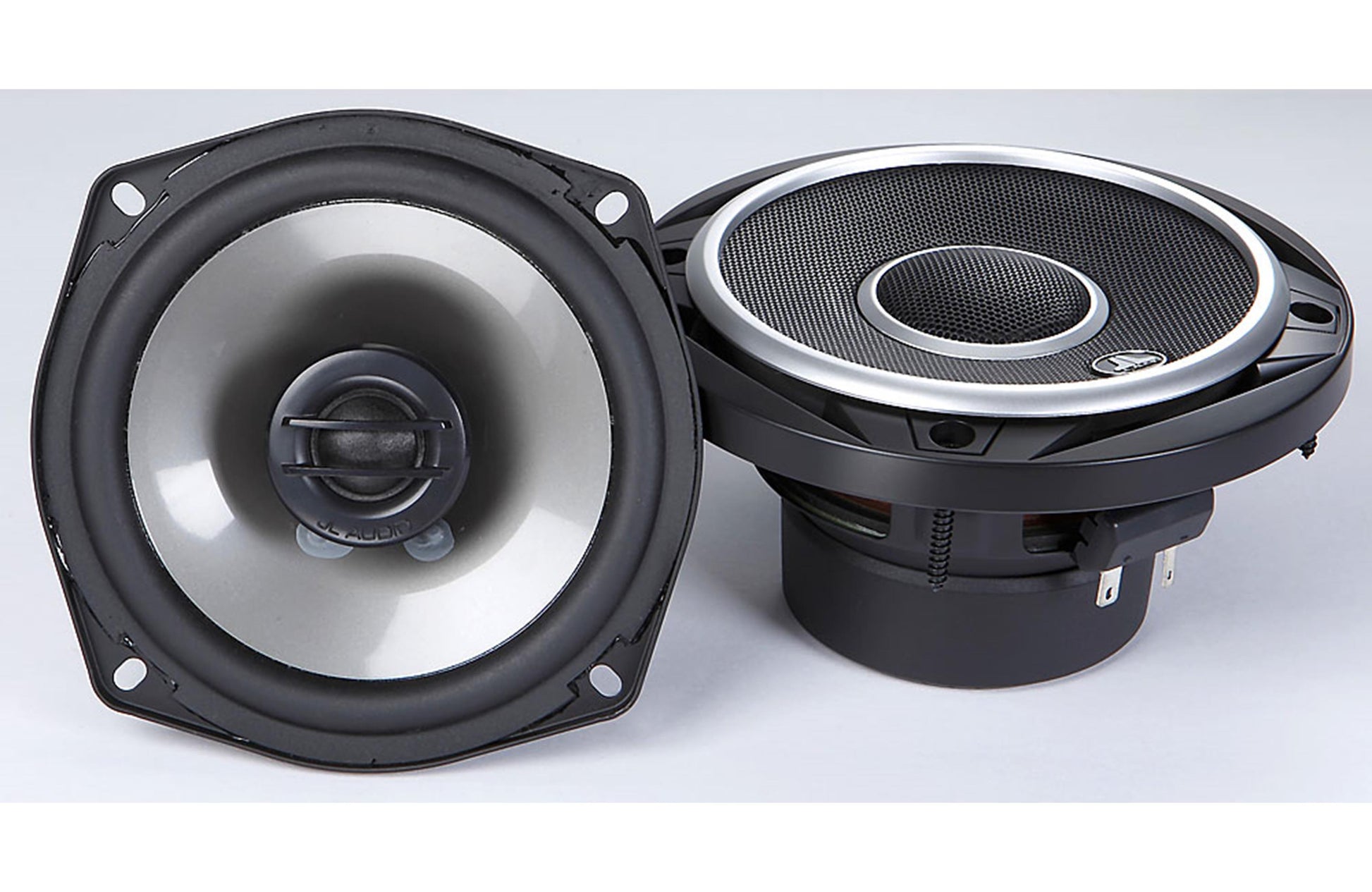 Pair of car speakers on a white 